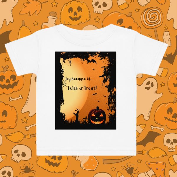 White t-shirt with Halloween-themed design on an orange background with pumpkins and ghosts.
