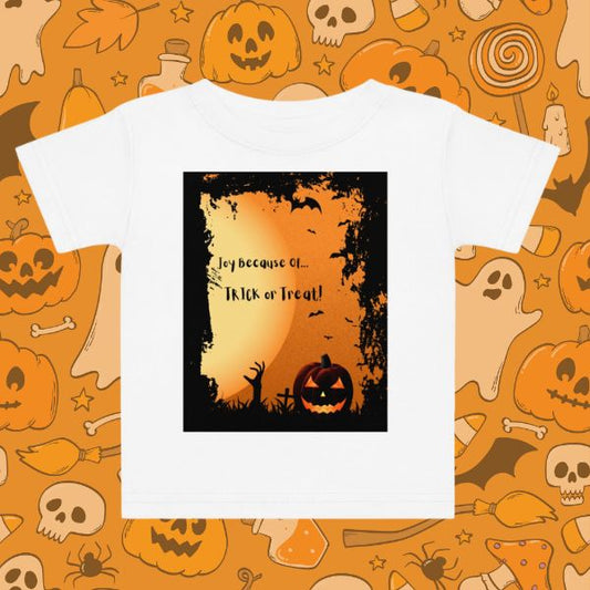 White t-shirt with Halloween-themed design on an orange background with pumpkins and ghosts.